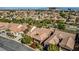 Aerial view of community homes with lush landscaping, with city skyline in background at 936 Viscanio Pl, Las Vegas, NV 89138