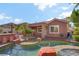 Charming home exterior showcasing the pool, spa, outdoor kitchen and well-manicured yard at 936 Viscanio Pl, Las Vegas, NV 89138