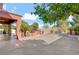 An expansive backyard with an outdoor kitchen, large patio, and beautifully manicured landscaping at 936 Viscanio Pl, Las Vegas, NV 89138