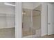 Elegant bathroom featuring a glass-enclosed shower with tiled surround and a walk-in closet in neutral tones at 936 Viscanio Pl, Las Vegas, NV 89138