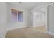 Well-lit bedroom featuring carpeted floors and an adjacent room separated by glass doors offering natural light at 936 Viscanio Pl, Las Vegas, NV 89138