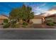 Well-maintained single-story home featuring a two-car garage and professionally landscaped front yard at 936 Viscanio Pl, Las Vegas, NV 89138