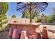 Outdoor kitchen and bar area with built-in seating, perfect for entertaining friends and Gathering at 936 Viscanio Pl, Las Vegas, NV 89138