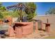 Outdoor kitchen and barbecue area with an umbrella for shade and a view of the pool at 936 Viscanio Pl, Las Vegas, NV 89138
