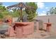 Outdoor kitchen area with a grill, and shaded dining, overlooking the pool at 936 Viscanio Pl, Las Vegas, NV 89138