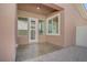A covered patio area featuring a door and windows, providing a seamless transition from indoor to outdoor living at 936 Viscanio Pl, Las Vegas, NV 89138
