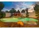 Inviting outdoor pool area with a rock waterfall feature and lush landscaping, perfect for relaxation at 936 Viscanio Pl, Las Vegas, NV 89138