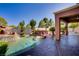 Inviting backyard boasts a sparkling pool with a waterfall feature and a covered outdoor kitchen at 936 Viscanio Pl, Las Vegas, NV 89138