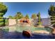 Inviting outdoor pool area with a rock waterfall feature and lush landscaping, perfect for relaxation at 936 Viscanio Pl, Las Vegas, NV 89138
