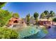 Backyard oasis features a sparkling pool with stone waterfall and lush landscaping at 936 Viscanio Pl, Las Vegas, NV 89138