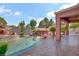 Beautiful backyard pool area with built-in seating and shaded outdoor kitchen at 936 Viscanio Pl, Las Vegas, NV 89138