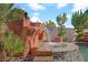 Stunning rock waterfall spilling into the pool, creating a tranquil spa-like experience at 936 Viscanio Pl, Las Vegas, NV 89138