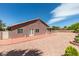 Spacious backyard with block wall, desert landscaping, red cement patio, and ample space at 9524 Tyler Rose St, Las Vegas, NV 89178