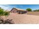 Spacious backyard featuring desert landscaping, red concrete patio, and building elevation at 9524 Tyler Rose St, Las Vegas, NV 89178