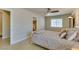 Cozy bedroom featuring a neutral color scheme, ceiling fan, and doorway to the ensuite bathroom at 9524 Tyler Rose St, Las Vegas, NV 89178