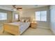 Inviting bedroom with neutral tones, a ceiling fan, and ample natural light from large windows at 9524 Tyler Rose St, Las Vegas, NV 89178
