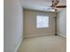 Minimalist bedroom features a ceiling fan, neutral carpet, a window with blinds and a reading lamp at 9524 Tyler Rose St, Las Vegas, NV 89178