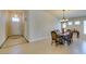 Bright dining area with tile flooring and a chandelier, conveniently located by the front entryway at 9524 Tyler Rose St, Las Vegas, NV 89178