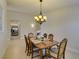 Cozy dining room with a vintage-style chandelier, positioned adjacent to a modern kitchen at 9524 Tyler Rose St, Las Vegas, NV 89178
