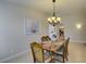 Elegant dining room illuminated by a stylish chandelier, situated next to the kitchen at 9524 Tyler Rose St, Las Vegas, NV 89178