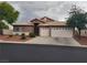 Charming single-story home features a two-car garage, desert landscaping, and a tile roof at 9524 Tyler Rose St, Las Vegas, NV 89178
