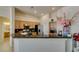 Bright kitchen boasts granite counters, stainless appliances, and raised breakfast bar seating at 9524 Tyler Rose St, Las Vegas, NV 89178