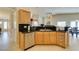 Open concept kitchen features granite counters, stainless appliances, and blends into adjacent dining area at 9524 Tyler Rose St, Las Vegas, NV 89178