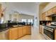 Bright kitchen showcases stainless appliances, granite countertops, and seamless flow into dining area at 9524 Tyler Rose St, Las Vegas, NV 89178