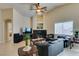 Comfortable living room with ceiling fan, tile floors, and fireplace at 9524 Tyler Rose St, Las Vegas, NV 89178