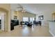 Spacious living room with a cozy fireplace, dining space, and access to the back patio at 9524 Tyler Rose St, Las Vegas, NV 89178