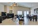 Bright living room with tile flooring, vaulted ceiling, fireplace, and leather furniture set at 9524 Tyler Rose St, Las Vegas, NV 89178