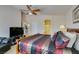 Large, vaulted main bedroom featuring a king bed, dresser, reading nook, and full television set at 9524 Tyler Rose St, Las Vegas, NV 89178