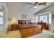 Spacious main bedroom showcasing a large bed, side tables, dresser, and a bay window nook at 9524 Tyler Rose St, Las Vegas, NV 89178