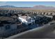 Expansive aerial view of a modern home in a planned community with stunning mountain views at 10204 Kern Peak St, Las Vegas, NV 89166