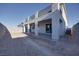 Backyard showcasing a patio with columns and unfinished landscaping at 10204 Kern Peak St, Las Vegas, NV 89166