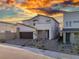 Contemporary two-story home with desert landscaping and a two-car garage during sunset at 10204 Kern Peak St, Las Vegas, NV 89166