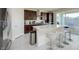 Beautiful kitchen with dark wood cabinetry, stainless appliances and a large center island with bar seating at 10204 Kern Peak St, Las Vegas, NV 89166