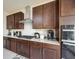 Well-appointed kitchen featuring dark wood cabinets and countertops, paired with stainless steel appliances at 10204 Kern Peak St, Las Vegas, NV 89166