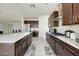 Modern kitchen with dark wood cabinetry, stainless steel appliances, and a large center island at 10204 Kern Peak St, Las Vegas, NV 89166