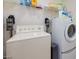 Laundry room featuring a washer, dryer, and ample shelving for storage at 10204 Kern Peak St, Las Vegas, NV 89166