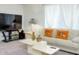 Cozy living room featuring neutral carpet and decor, a white sofa with comfortable pillows at 10204 Kern Peak St, Las Vegas, NV 89166