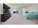 Main bedroom featuring neutral carpet, a bed, TV, and set of sliding doors leading to a balcony at 10204 Kern Peak St, Las Vegas, NV 89166