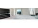 Main bedroom featuring neutral carpet, a queen size bed, TV, and set of sliding doors leading to a balcony at 10204 Kern Peak St, Las Vegas, NV 89166