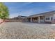 Spacious backyard with gravel landscaping, covered patio, and privacy fence; ideal for outdoor living at 10311 Slope Ridge St, Las Vegas, NV 89131