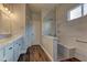 Bathroom featuring a glass shower with a bench, marble countertops and wood floors at 10311 Slope Ridge St, Las Vegas, NV 89131