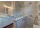 Bathroom with a glass shower featuring grey tile, marble counters and wood floors at 10311 Slope Ridge St, Las Vegas, NV 89131