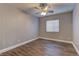 Bedroom with a fan, window, and wood floors at 10311 Slope Ridge St, Las Vegas, NV 89131