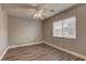 Bedroom with a fan, window, and wood floors at 10311 Slope Ridge St, Las Vegas, NV 89131