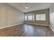 Bright bedroom features wood floors, ceiling fan, and large windows at 10311 Slope Ridge St, Las Vegas, NV 89131