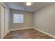 Bedroom featuring a closet, window, and wood floors at 10311 Slope Ridge St, Las Vegas, NV 89131